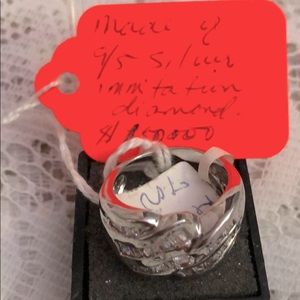 Ring Made of 9/5 Silver; and imitation diamond.